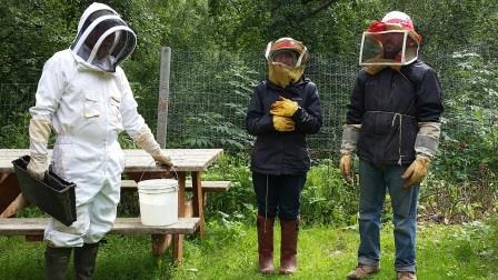 Pete with Eva and Sean getting ready to feed bees